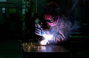 Welder working on a metal plate