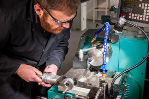 Man wearing glasses using tools